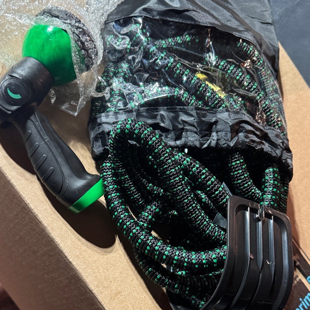 Green and Black Garden Hose with Spray Nozzle